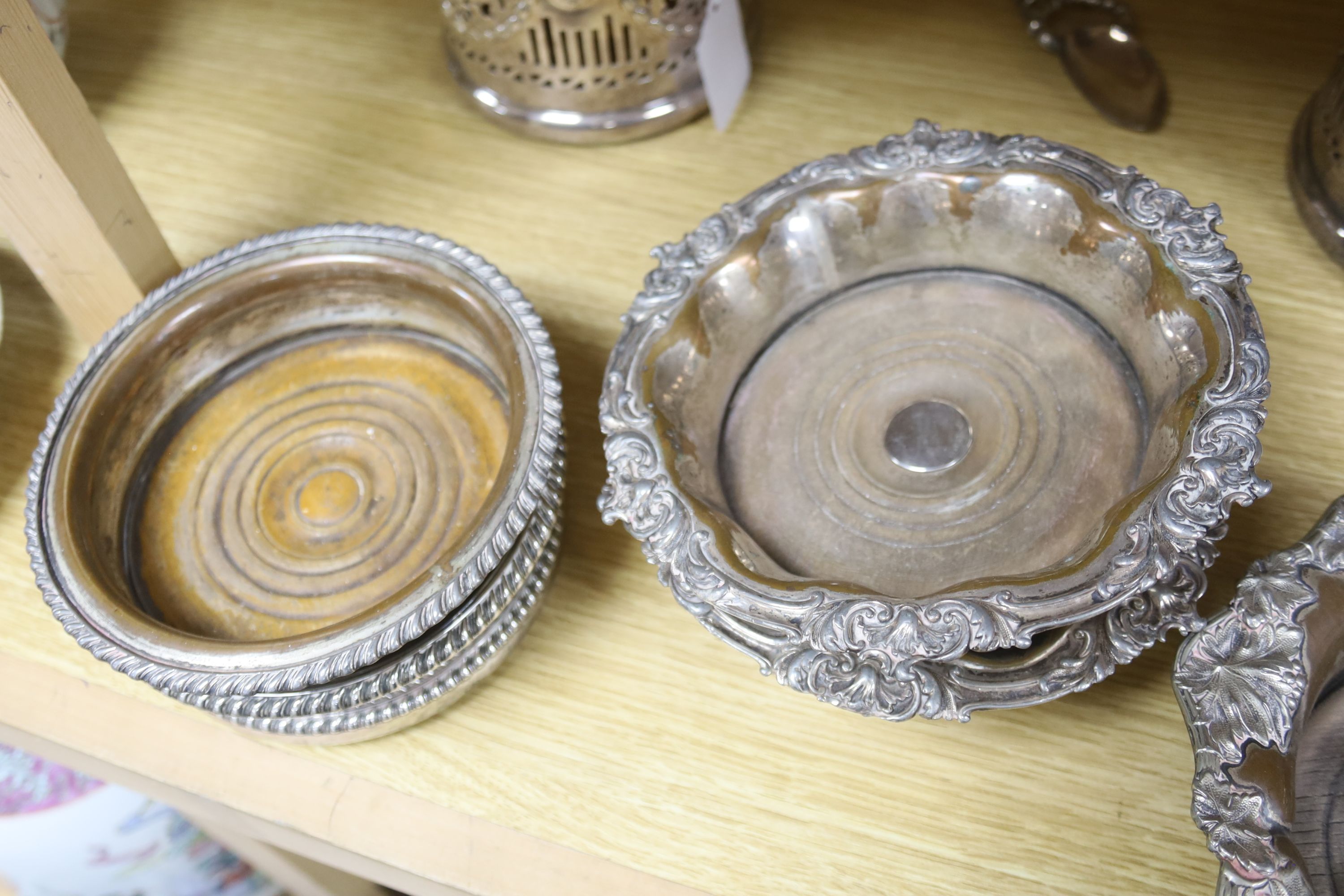 A pair of late Victorian pierced silver plated magnum coasters, height 12cm, two other pairs of plated wine coasters, one other and two spoons.